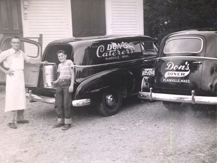 Black and white photo of Don Sr. behind the counter in the 1940's
